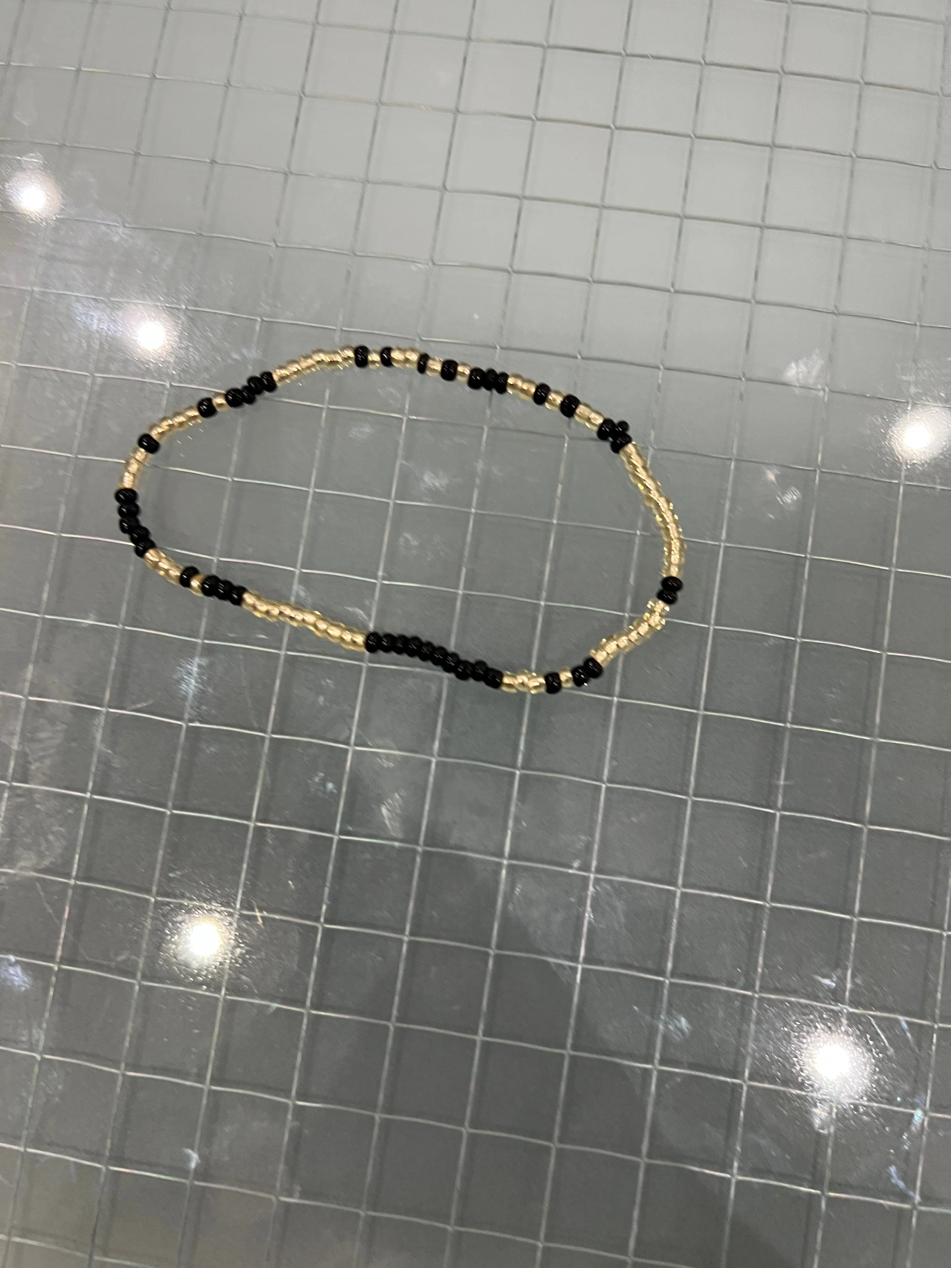 Black and gold anklet