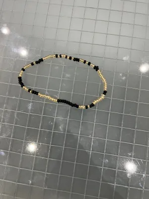 Black and gold anklet